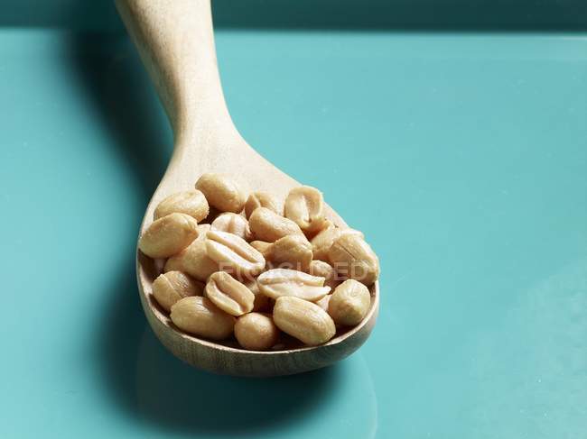 Peanuts on a wooden spoon — Stock Photo