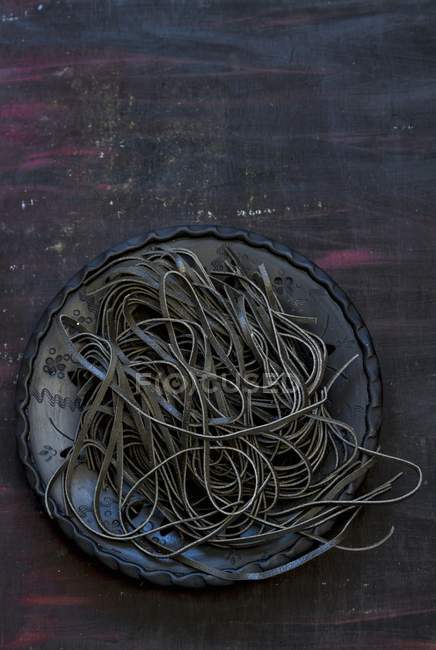 Black tagliatelle pasta — Stock Photo