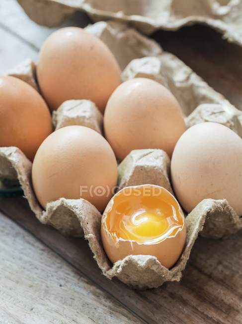 Fresh organic eggs in egg box — Stock Photo