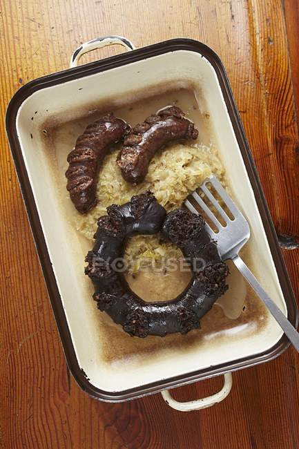 Черный пудинг, печеночные колбаски и квашеная капуста — стоковое фото