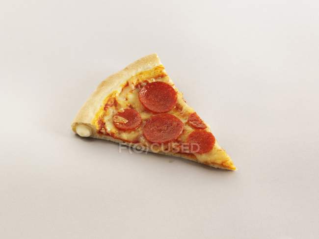 Slice of crust pizza with pepperoni — Stock Photo