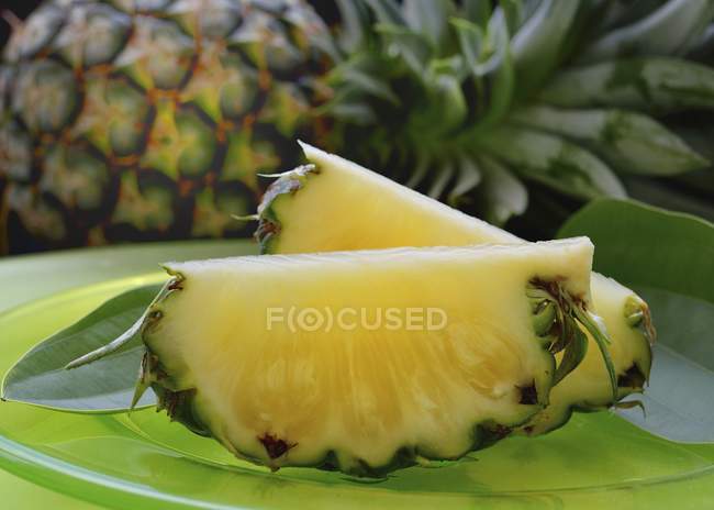 Pineapple slices on plate — Stock Photo
