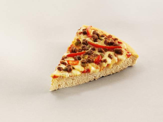 Slice of pizza with chilli peppers — Stock Photo