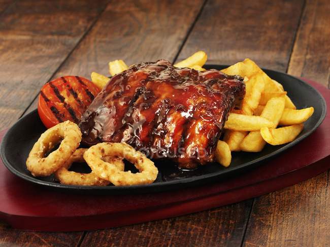 Glazed ribs with chips — Stock Photo