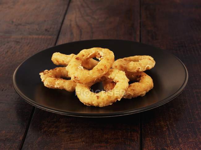 Fried onion rings in glass bowl — Stock Photo