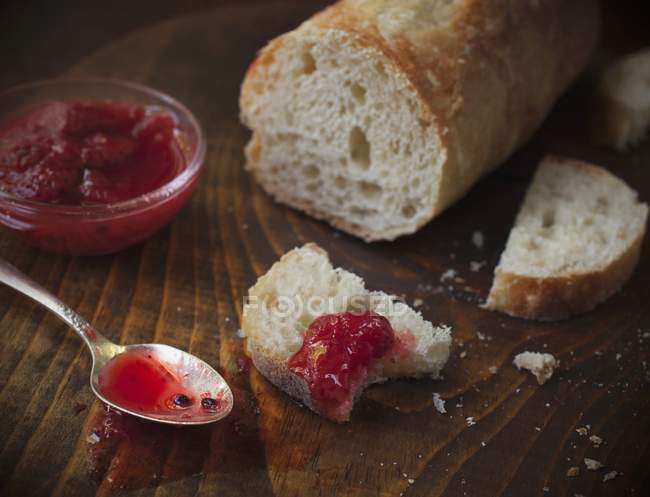 Closeup view of baguette with fresh strawberry jam — Stock Photo
