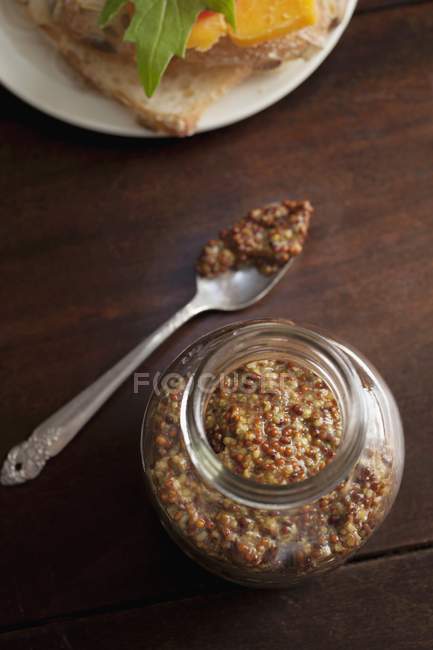 Jar of wholegrain Dijon mustard — Stock Photo