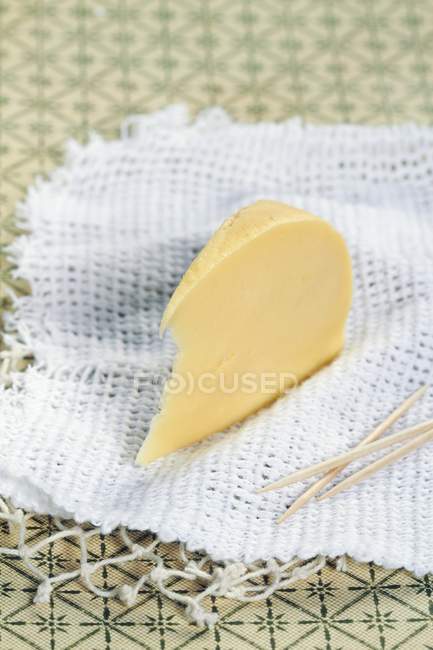 Wedge of cow's milk cheese — Stock Photo