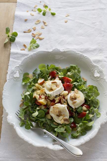 Goat's cheese with flaked almonds — Stock Photo