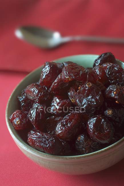 Dried cranberries in ceramic bowl — Stock Photo