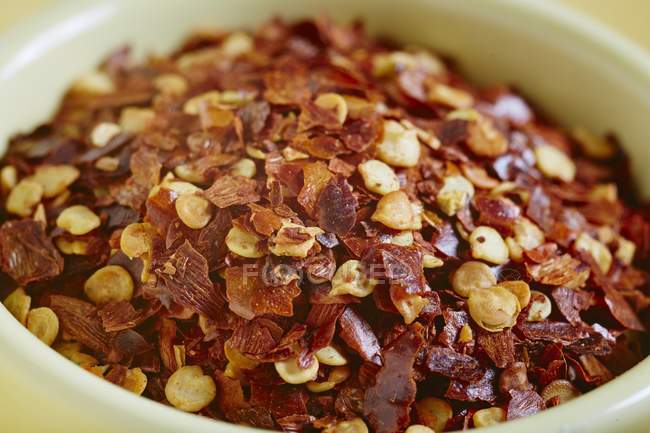 Closeup view of a bowl of dried chilli flakes — Stock Photo