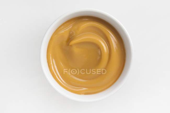 Butterscotch pudding in white bowl — Stock Photo