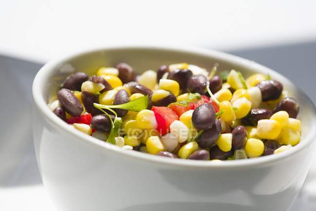Corn salad with beans in white dish — Stock Photo