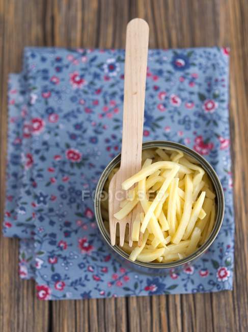 Bamboo shoots in a tin with a wooden fork over towel — Stock Photo