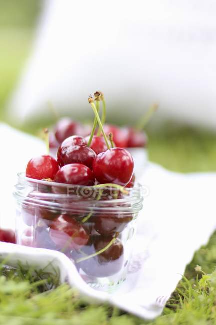 Jar of fresh picked cherries — Stock Photo