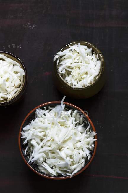 Bowls of shredded white cabbage — Stock Photo
