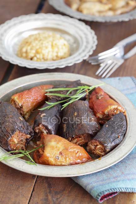 Gefüllte Paprika und Auberginen mit Pilau auf Teller über Handtuch — Stockfoto