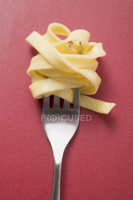 Cooked ribbon pasta on fork — Stock Photo