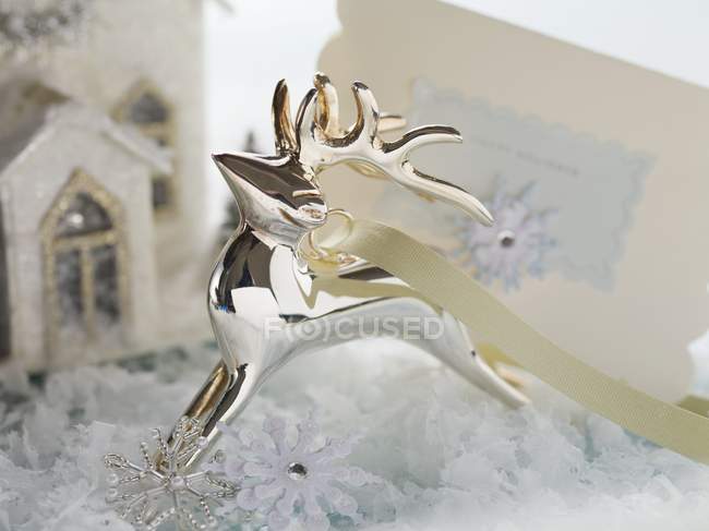 Silver reindeer and Christmas card — Stock Photo