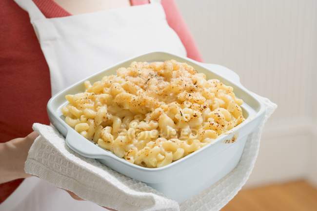 Woman holding macaroni and cheese — Stock Photo