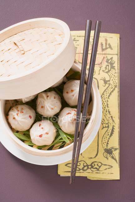Top view of Dim Sum in bamboo steamer with chopsticks — Stock Photo