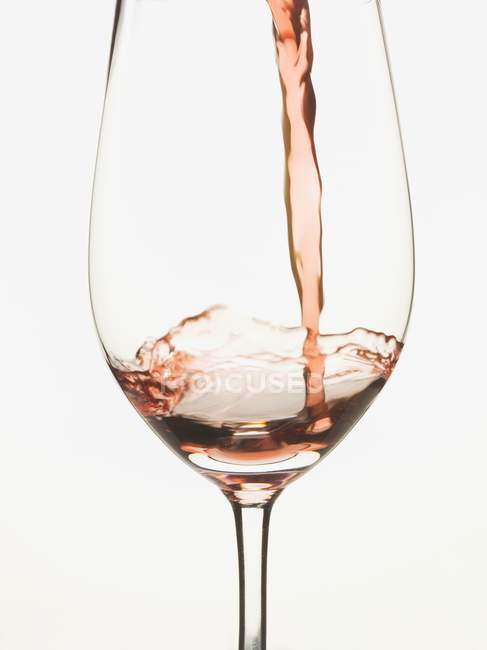 Red wine poured into glass — Stock Photo