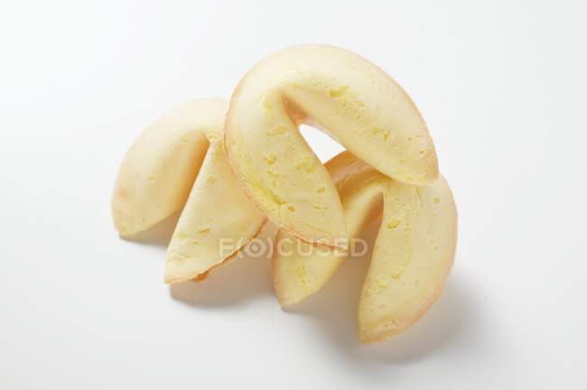 Closeup view of three fortune cookies on white surface — Stock Photo