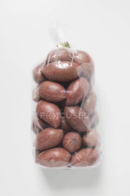 Pecans in cellophane bag — Stock Photo