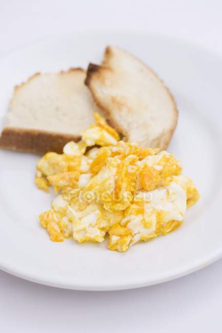 Scrambled egg with toasts — Stock Photo