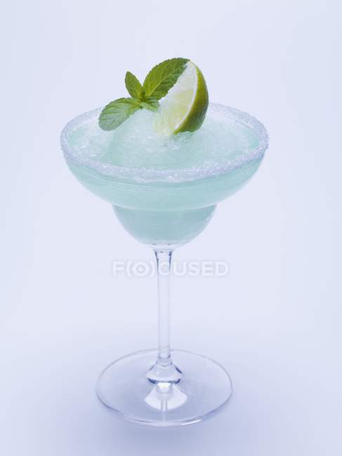 Frozen Margarita with lime wedge and mint — Stock Photo
