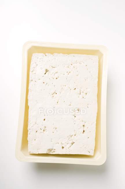 Closeup top view of Tofu cheese in plastic container — Stock Photo