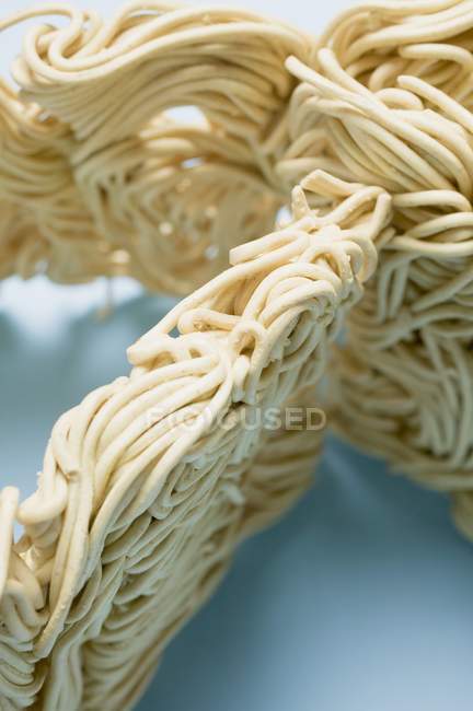 Closeup view of dry egg noodles blocks — Stock Photo