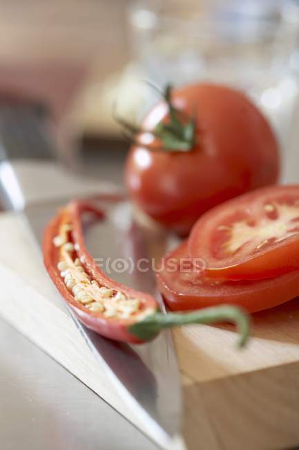 Tomatoes and half of chilli — Stock Photo