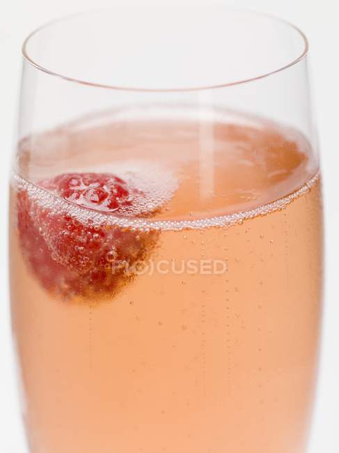 Sparkling wine cocktail with raspberry — Stock Photo