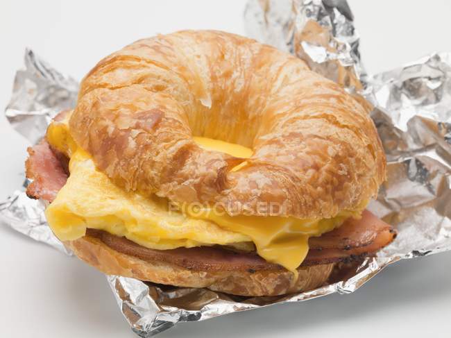 Croissant filled with scrambled egg — Stock Photo