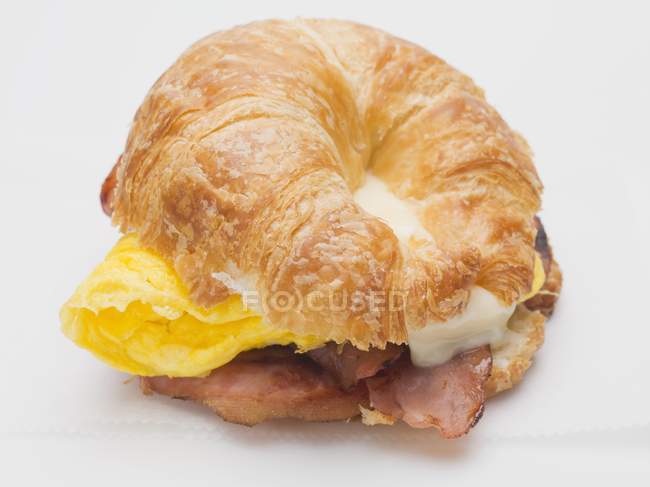 Croissant filled with bacon — Stock Photo
