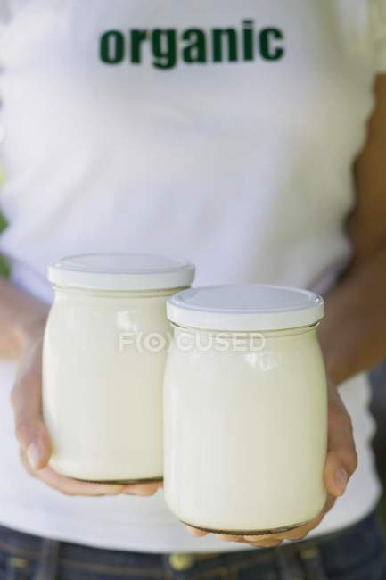 Hands holding jars — Stock Photo