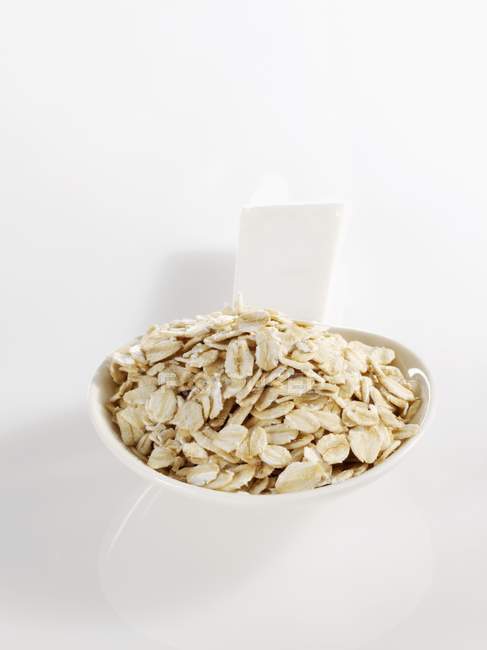 Spoonful of rolled oats — Stock Photo