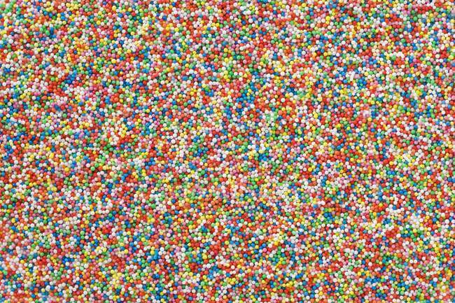 Top full-frame view of colorful sweet sprinkles — Stock Photo