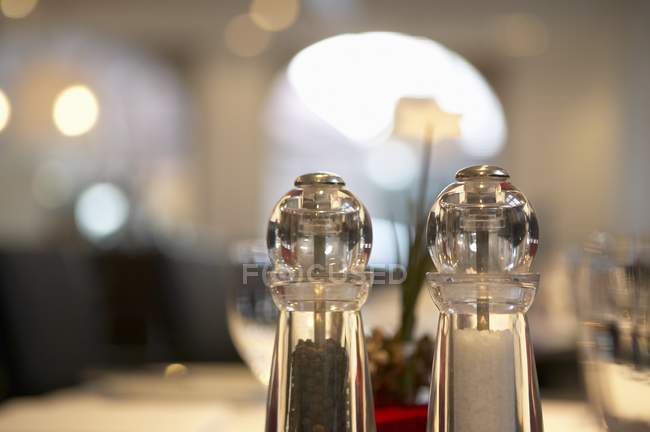 Closeup view of salt and pepper in casters on table — Stock Photo