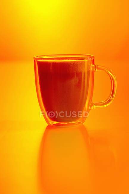 Closeup view of coffee with orange liqueur and milk foam — Stock Photo