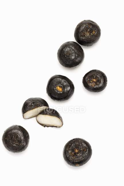 Whole and halved water chestnuts — Stock Photo