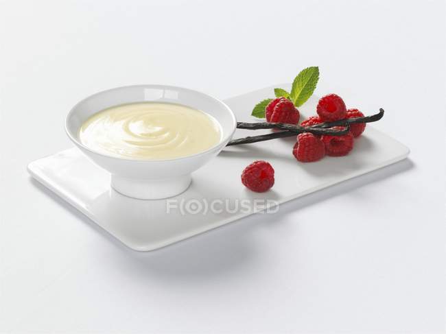 Closeup view of vanilla cream with raspberries — Stock Photo