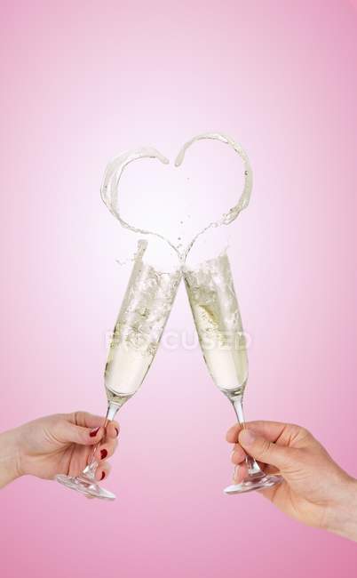 Clinking glasses of sparkling wine — Stock Photo