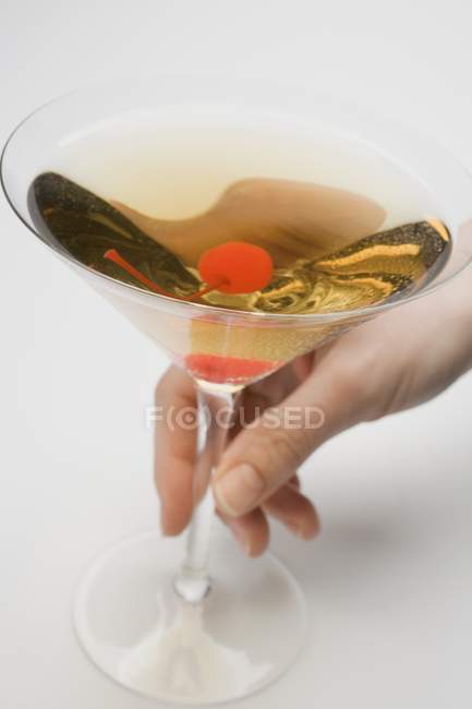 Female Hand holding glass of Manhattan — Stock Photo