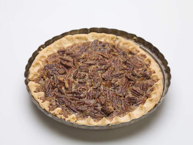 Whole pecan pie in baking dish — Stock Photo