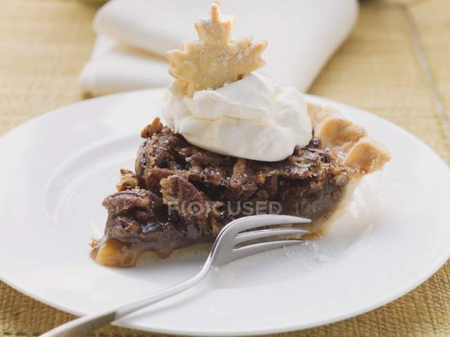 Piece of pecan pie with cream — Stock Photo
