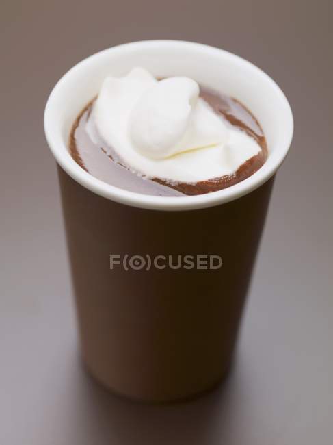 Hot chocolate with cream in beaker — Stock Photo