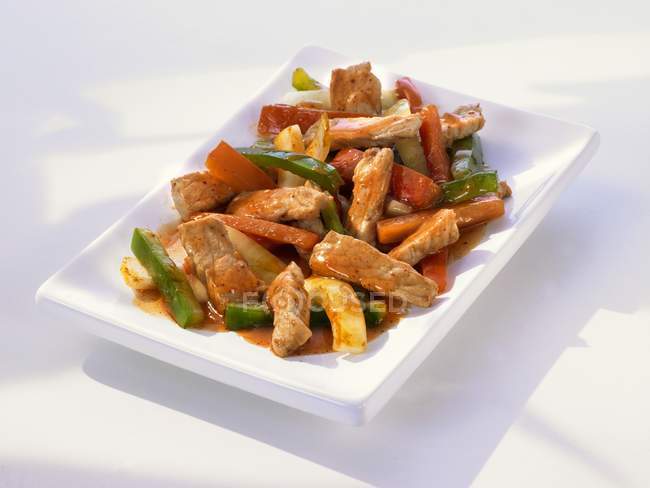 Sweet and sour pork with peppers — Stock Photo