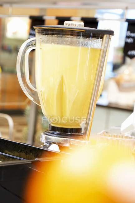 Fruit shake in jug at kitchen interior — Stock Photo